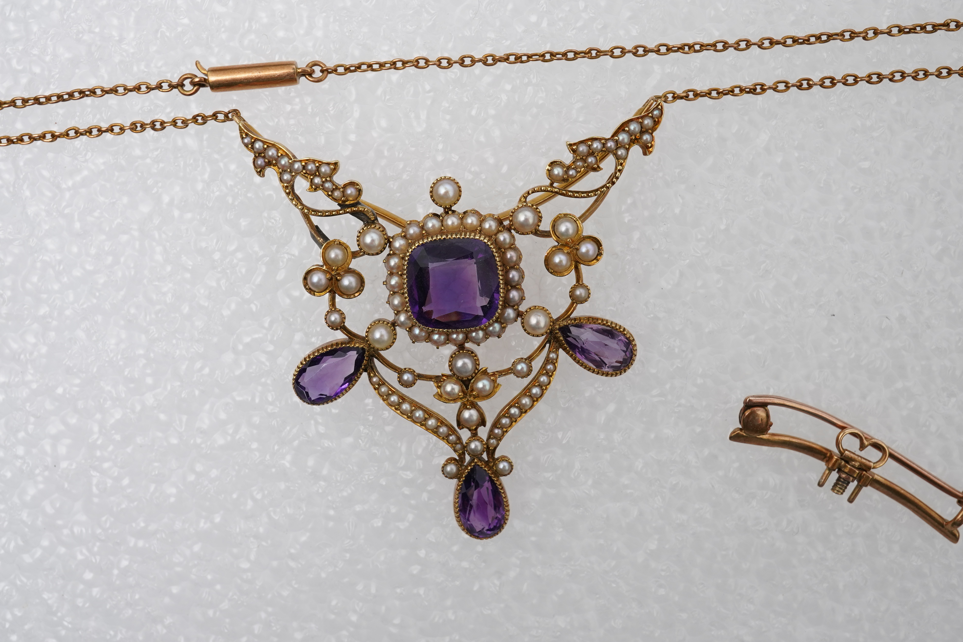 An Edwardian seed pearl and amethyst pendant/brooch, early 20th century